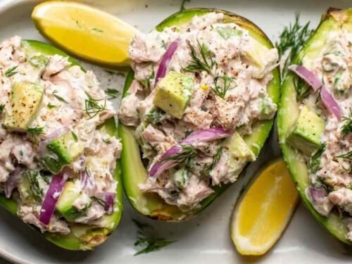 Avocado Tuna Salad Boats filled with creamy tuna mixture on a plate