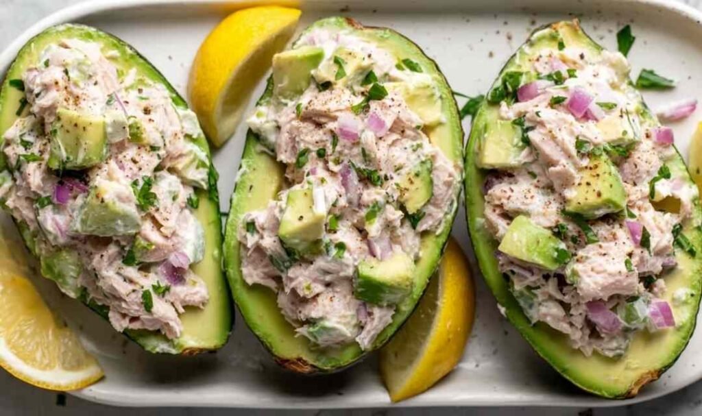 Avocado Tuna Salad Boats filled with creamy tuna mixture on a plate