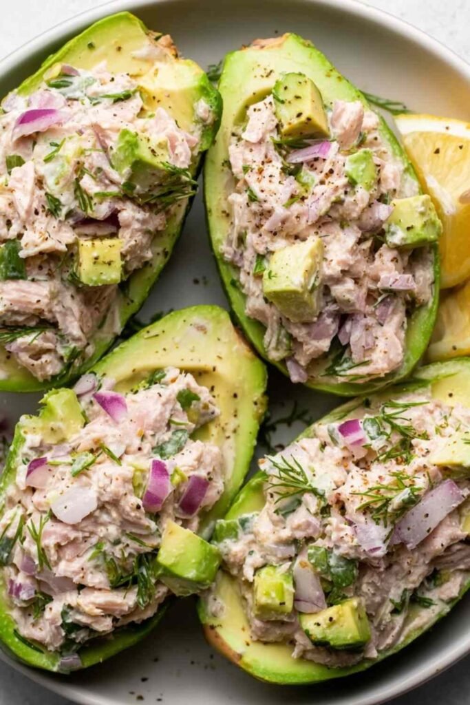 Avocado Tuna Salad Boats filled with creamy tuna mixture on a plate