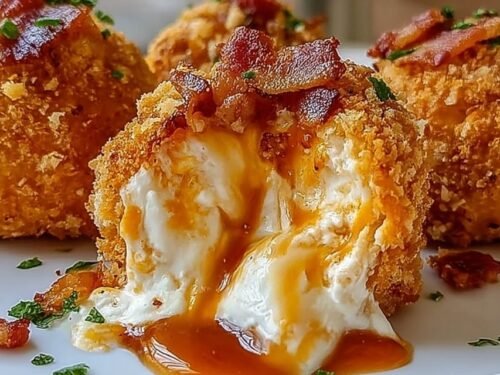 Crispy buffalo chicken bacon mozzarella bombs on a plate drizzled with buffalo sauce