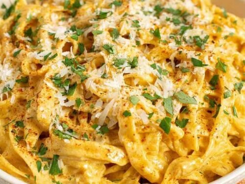 Creamy Cajun Alfredo sauce tossed with fettuccine pasta, topped with freshly grated Parmesan and chopped herbs