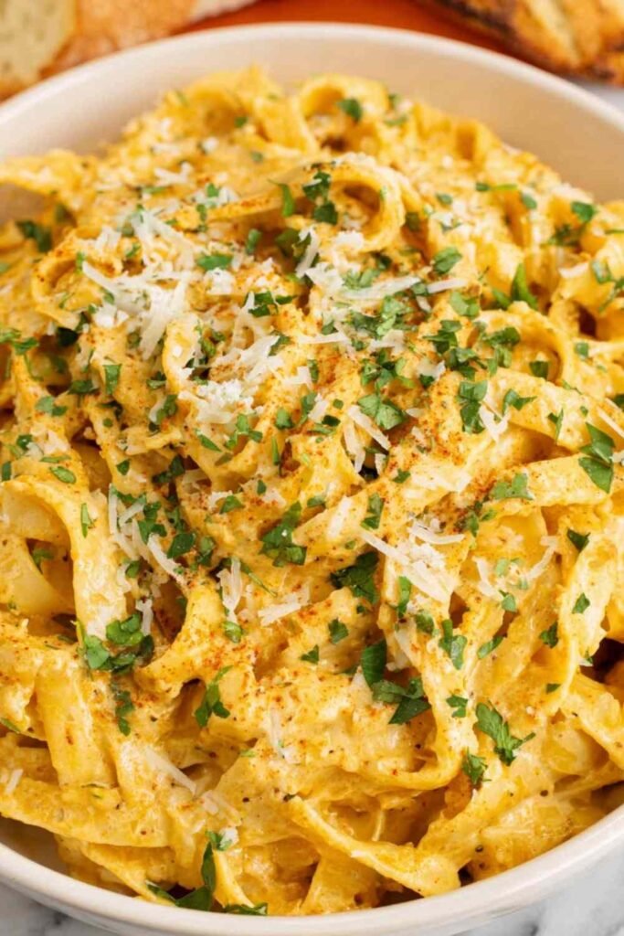 Creamy Cajun Alfredo sauce tossed with fettuccine pasta, topped with freshly grated Parmesan and chopped herbs