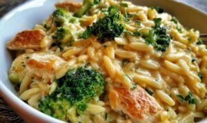 Cheesy Chicken Broccoli Orzo Creamy cheesy chicken broccoli orzo served in a large skillet with melted cheddar and fresh broccoli