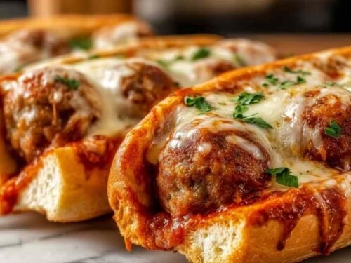Cheesy Meatball Subs with melted mozzarella on a toasted hoagie roll.