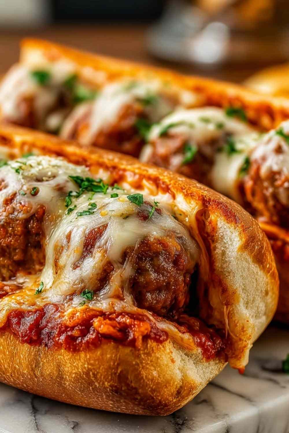 Cheesy Meatball Subs with melted mozzarella on a toasted hoagie roll.