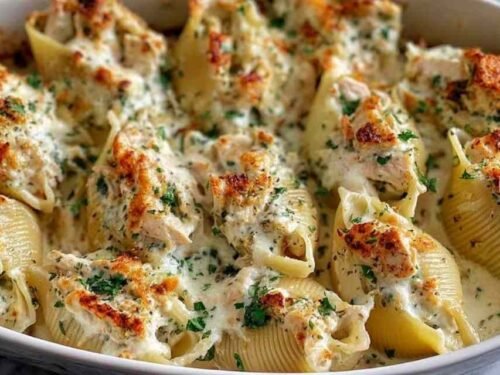 Chicken Alfredo Stuffed Shells in a baking dish ready for the oven