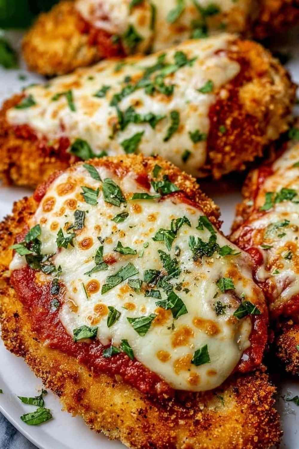Chicken Parmesan with melted mozzarella cheese and marinara sauce