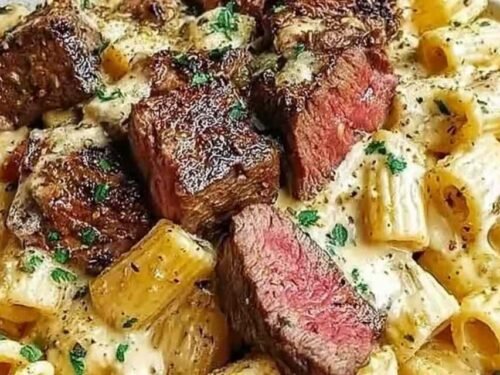 Cowboy Butter Steak Pasta in a large skillet with seared steak pieces, garlic butter sauce, and fresh parsley