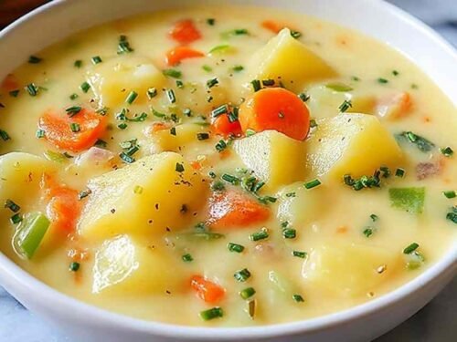 Easy Creamy Potato Soup cooking in a large pot on the stove.