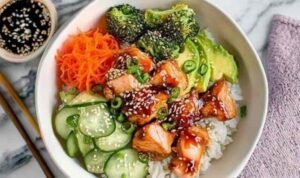 Crispy salmon bowls with avocado and cucumber over rice.