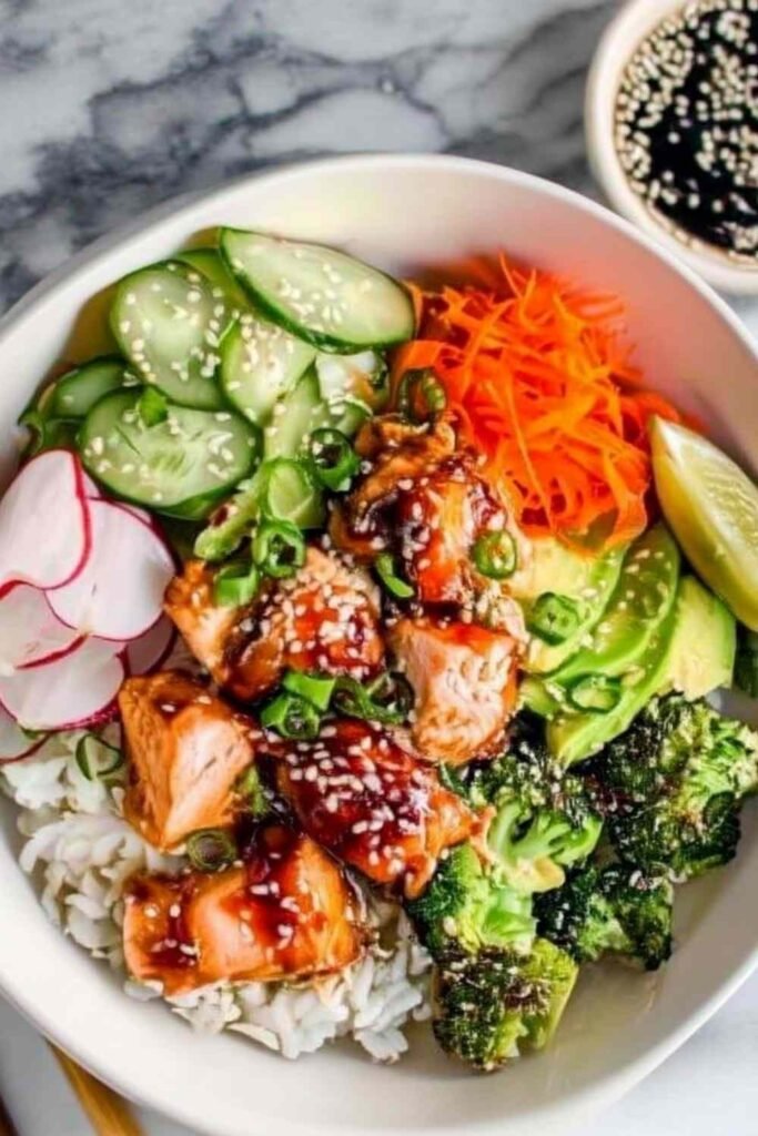 Crispy salmon bowls with avocado and cucumber over rice.