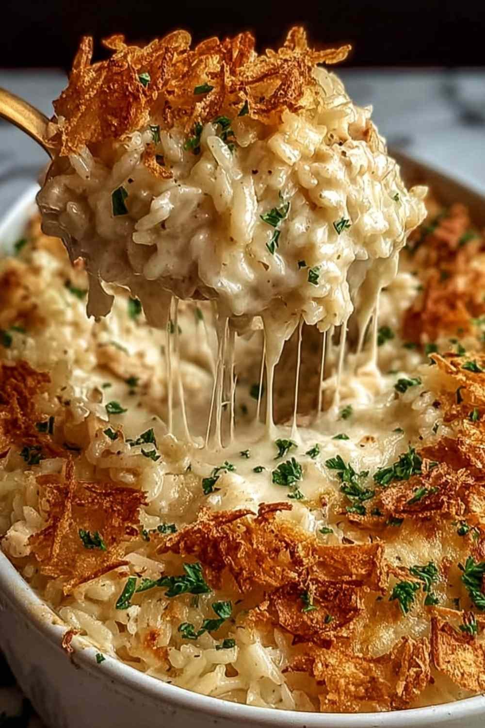 A baking dish of golden French Onion Chicken Rice Bake topped with melted cheese and crispy onions.