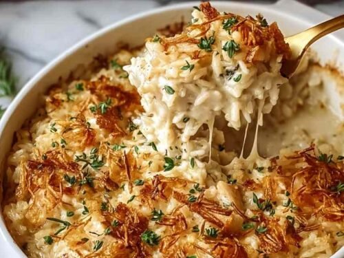 French Onion Chicken Rice Bake in a white baking dish with golden crispy onions and melted cheese on top