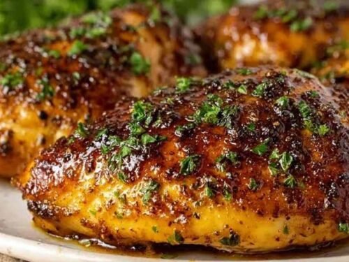 Garlic Brown Sugar Chicken cooking in a skillet with a sticky brown glaze