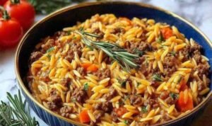 Ground beef orzo Creamy ground beef orzo recipe served in a large skillet topped with freshly grated Parmesan cheese