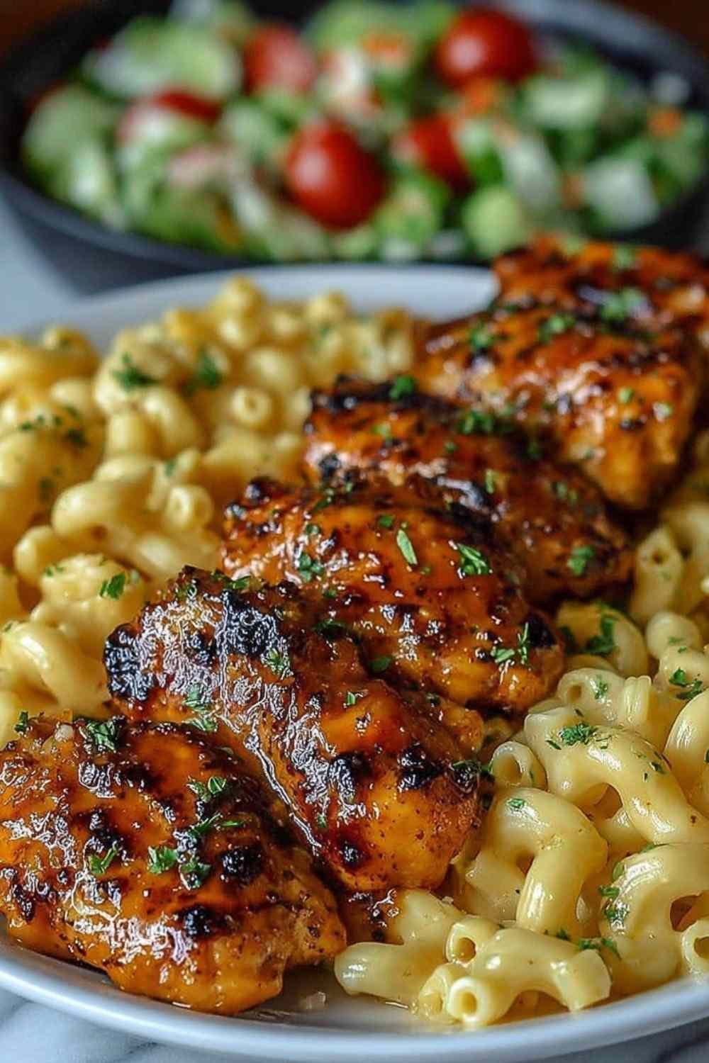Honey Garlic Glazed Chicken Cooking Alt Text: High Protein Honey Garlic Butter Chicken with Mac & Cheese cooking in a cast iron skillet with golden honey glaze