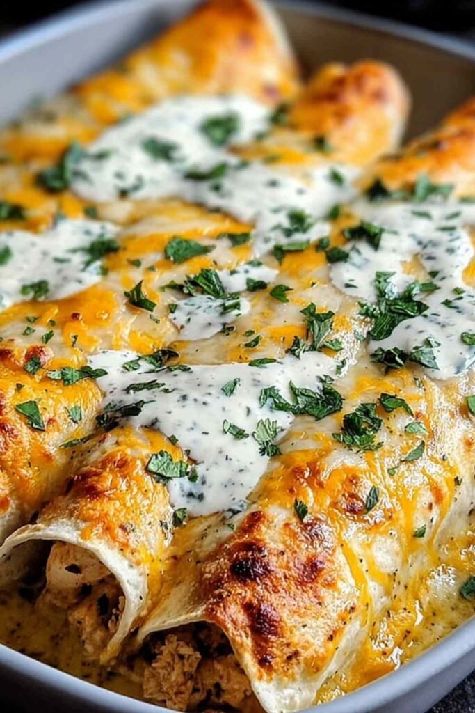 High protein chicken enchiladas in a baking dish topped with melted cheese and fresh cilantro