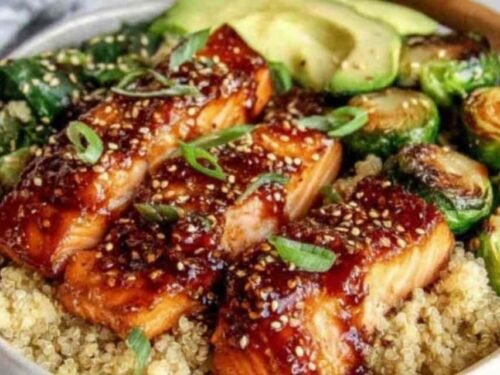 Brushing honey glaze onto salmon fillets in a skillet for Honey Glazed Salmon Bowl
