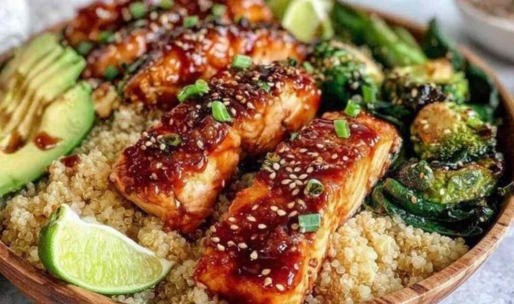 Brushing honey glaze onto salmon fillets in a skillet for Honey Glazed Salmon Bowl