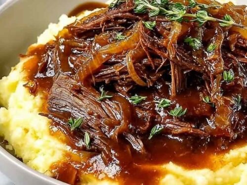 Juicy French Onion Pot Roast with caramelized onions and fresh herbs in a Dutch oven