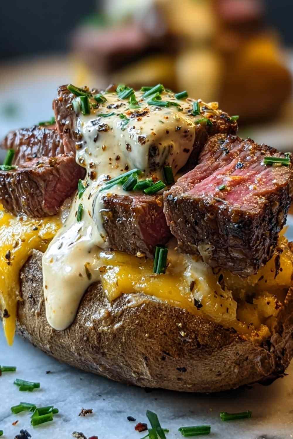 Loaded steak potatoes topped with Cajun steak bites and creamy Parmesan sauce on a rustic dinner plate