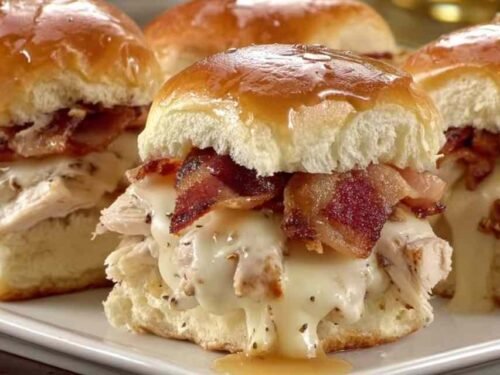 Maple chicken bacon sliders stacked on golden Hawaiian rolls with melted Gouda cheese and crispy bacon