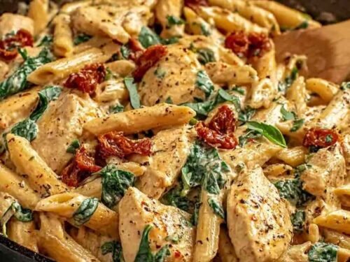 Marry Me Chicken Pasta in a creamy sun-dried tomato sauce in a cast iron skillet