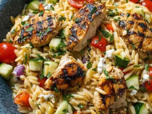 Fresh ingredients for Mediterranean chicken orzo including spinach and sun-dried tomatoes