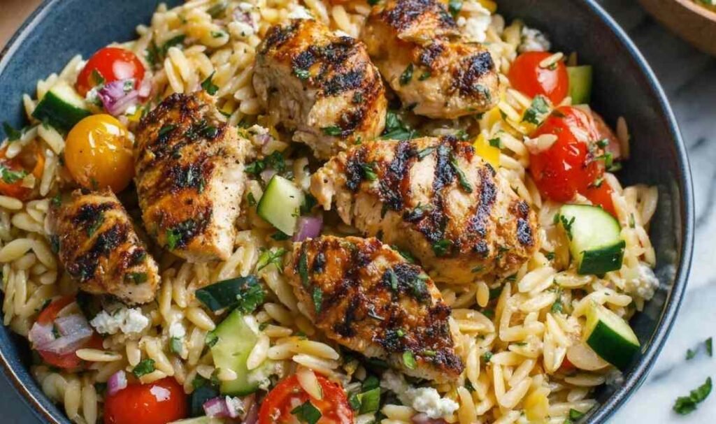 Fresh ingredients for Mediterranean chicken orzo including spinach and sun-dried tomatoes