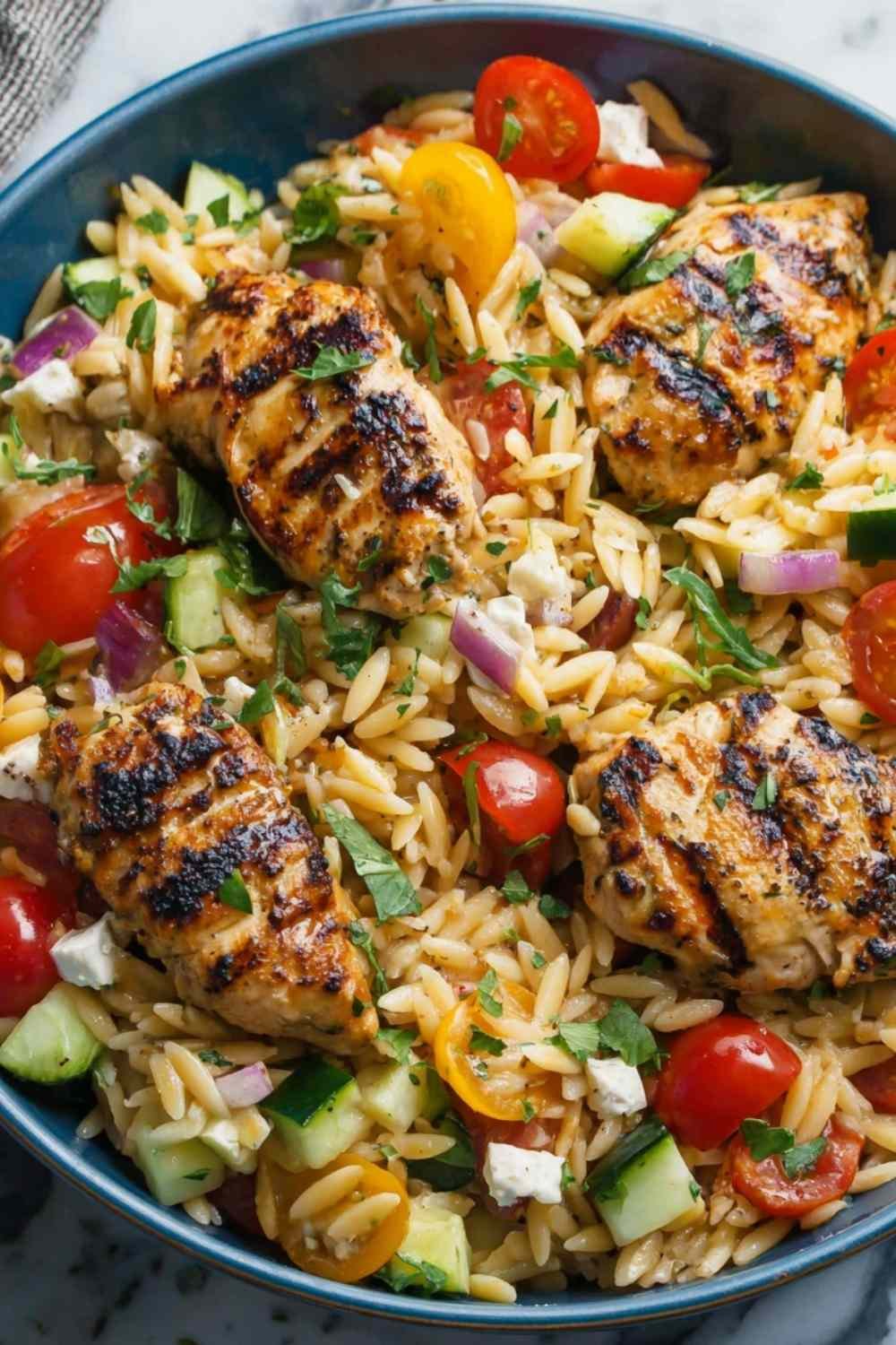Fresh ingredients for Mediterranean chicken orzo including spinach and sun-dried tomatoes