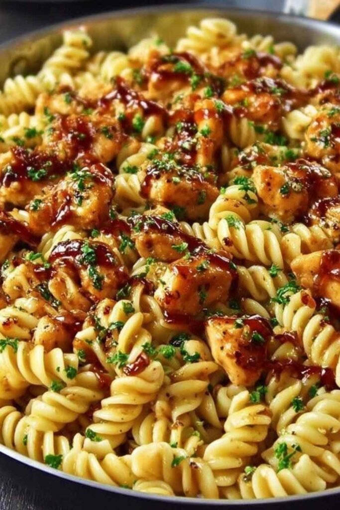 One Pot Honey Garlic BBQ Chicken Pasta cooking in a pot on the stove