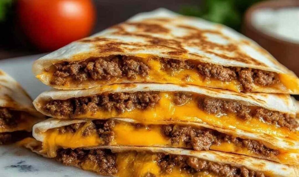 Smashburger Quesadillas cooking in a cast iron skillet with melting cheese