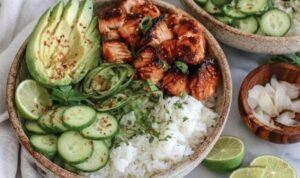 Spicy Salmon Bowl Spicy Salmon Bowl Recipe salmon cooking in a skillet with glaze