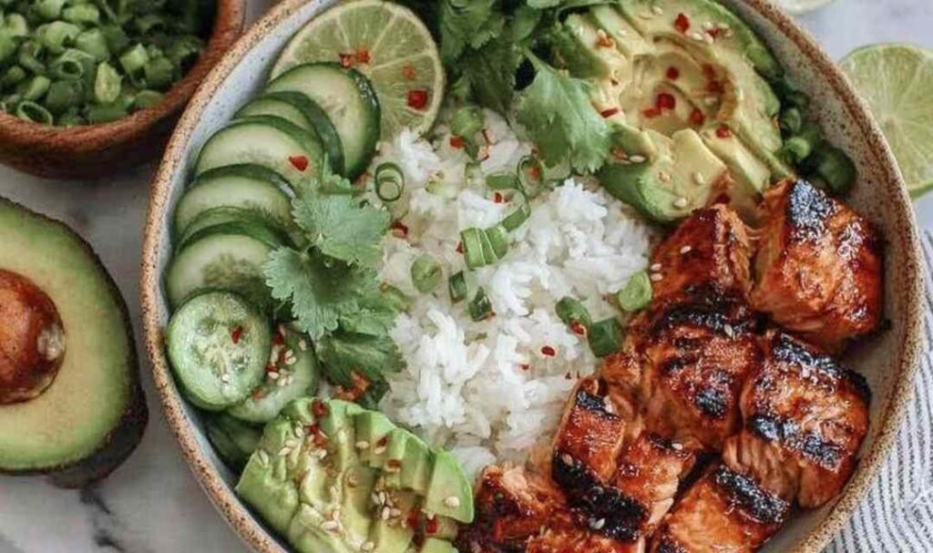 Spicy Salmon Bowl Recipe salmon cooking in a skillet with glaze