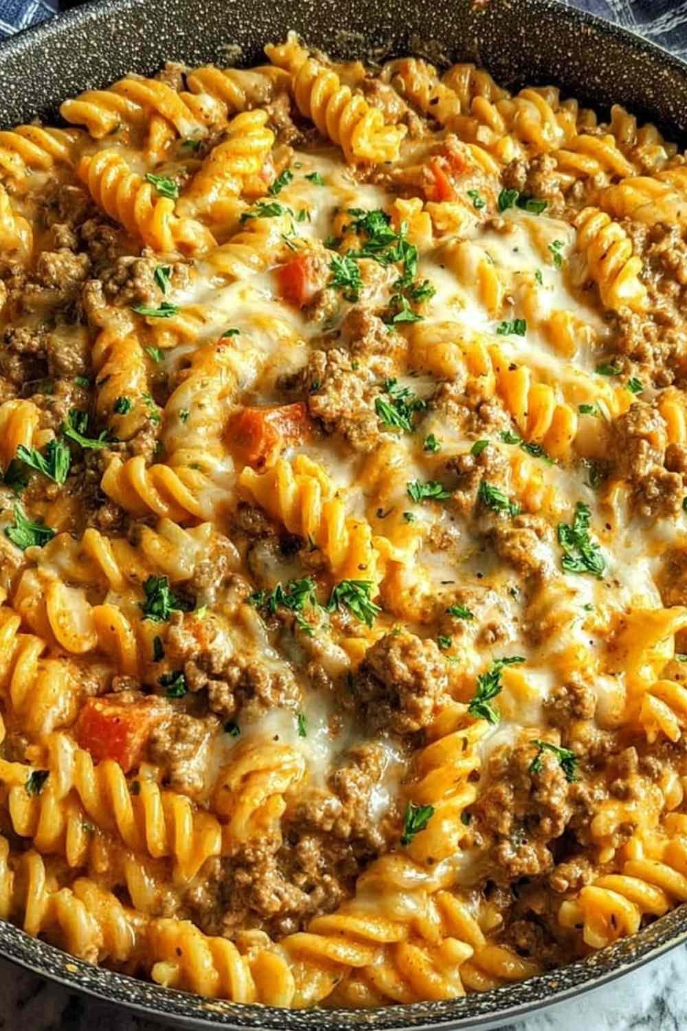 Stovetop Creamy Ground Beef Pasta cooking in a skillet