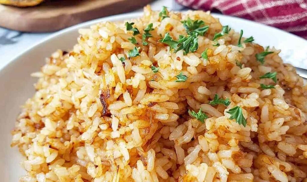 Texas Roadhouse Seasoned Rice cooking in a cast iron skillet