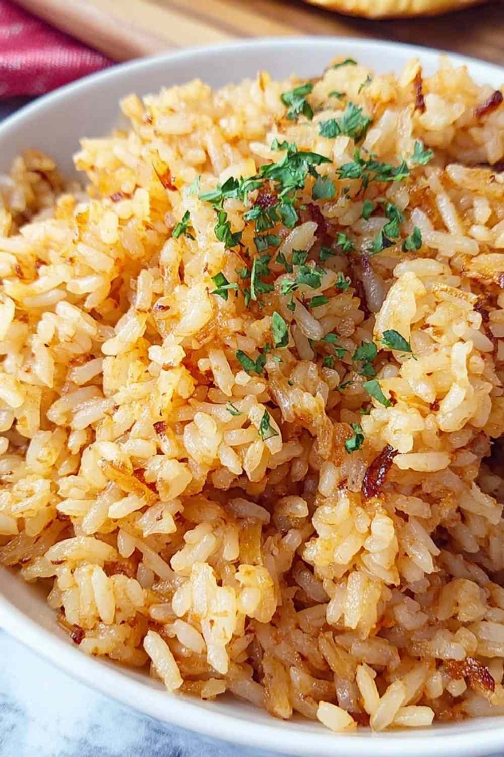 Texas Roadhouse Seasoned Rice cooking in a cast iron skillet