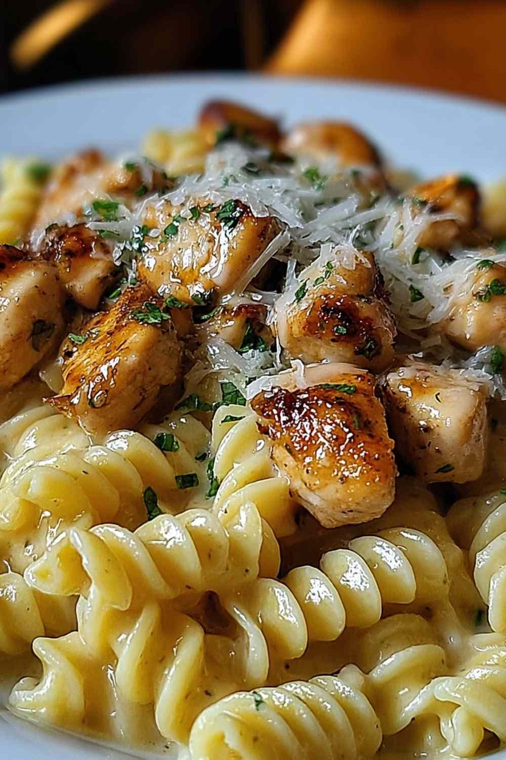 Twisted Pasta with Honey Garlic Chicken and Parmesan Cream on a white plate