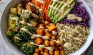 Fresh ingredients for a Vegan Buddha Bowl arranged on a wooden countertop