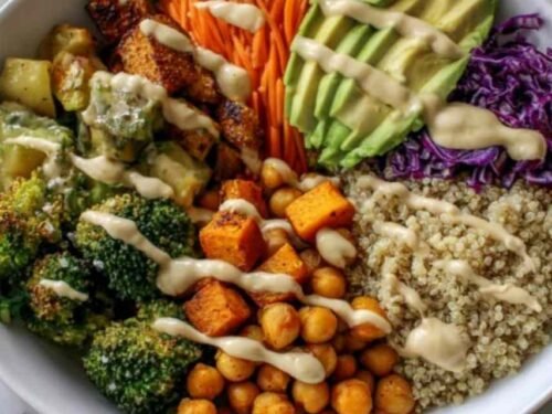 Fresh ingredients for a Vegan Buddha Bowl arranged on a wooden countertop