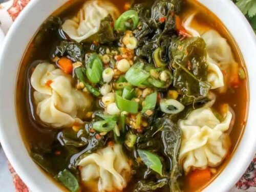 10 Minute Wonton Soup ingredients in a bowl including fresh ginger and frozen wontons