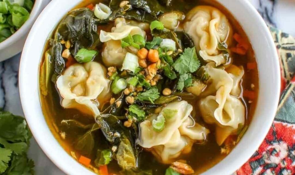 10 Minute Wonton Soup ingredients in a bowl including fresh ginger and frozen wontons