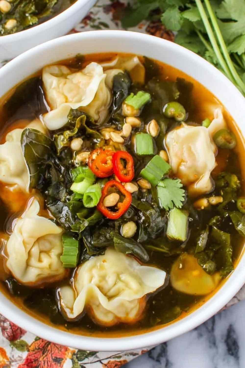 10 Minute Wonton Soup ingredients in a bowl including fresh ginger and frozen wontons