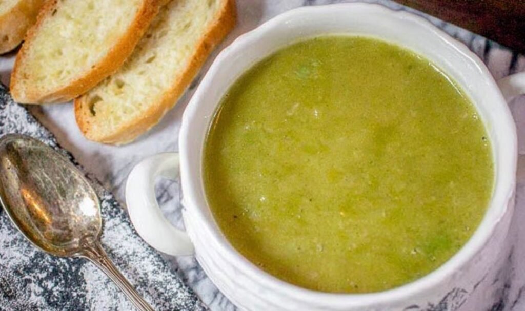 A pot of freshly cooked 30 minute frozen pea soup on a stove