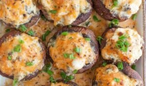 Raw bacon blue cheese stuffed mushrooms in a baking dish ready for the oven