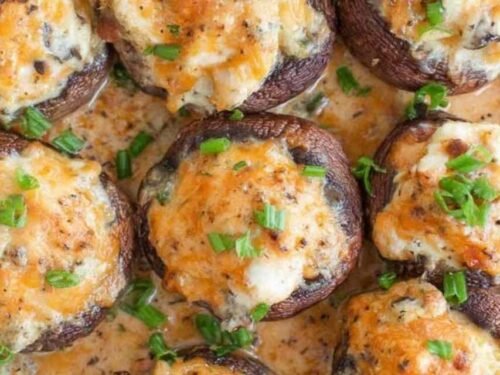 Raw bacon blue cheese stuffed mushrooms in a baking dish ready for the oven