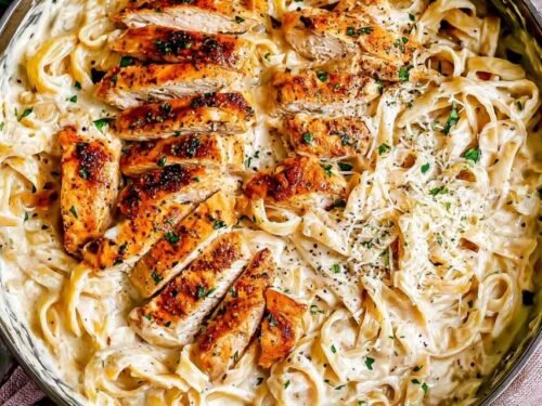 Sliced chicken cutlets seasoned with paprika for chicken fettuccine alfredo