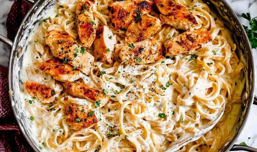 Sliced chicken cutlets seasoned with paprika for chicken fettuccine alfredo
