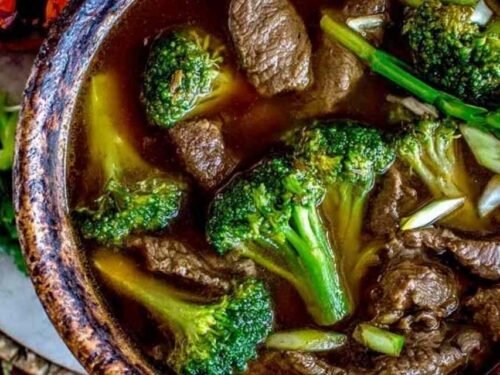 Bowl of Chinese beef and broccoli soup with tender flank steak slices and crisp broccoli florets in a dark savory broth