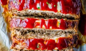 Cream cheese stuffed meatloaf Sliced cream cheese stuffed meatloaf showing a creamy filling on a white serving plate